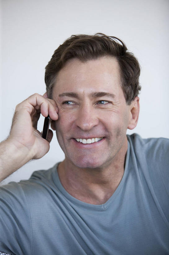 西方人,脸,头,脸颊,脖子,手,一个人,笑,打电话,微笑,露齿笑,竖图,室内,特写,白天,正面,电话,手机,欧洲,欧洲人,仅一个男性,仅一个人,仅一个中年男性,握,阴影,服装,反射,影子,墙,拿,听,拿着,注视,休闲装,通讯设备,肩膀,墙壁,墙面,衣服,蓝色,白色,观察,看,休闲,手部,休闲服,握着,服饰,观看,单手,察看,关注,一部,交流,男人,男性,中年男性,白种人,头部,脖,颈,颈部,脸部,脸蛋,面部,沟通,通话,半身,彩图