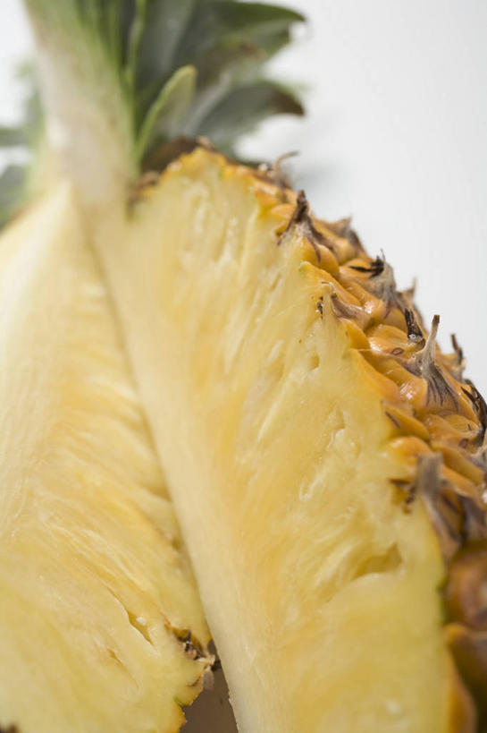 无人,竖图,俯视,室内,特写,白天,白色背景,餐桌,桌子,菠萝,水果,切开,阴影,新鲜,反射,影子,生食,食品,果实,半个,食物,黄色,切,一半,摄影,有机食品,绿色食品,影棚,餐台,剖面,切面,凤梨,彩图,高角度拍摄,影棚拍摄,拍摄